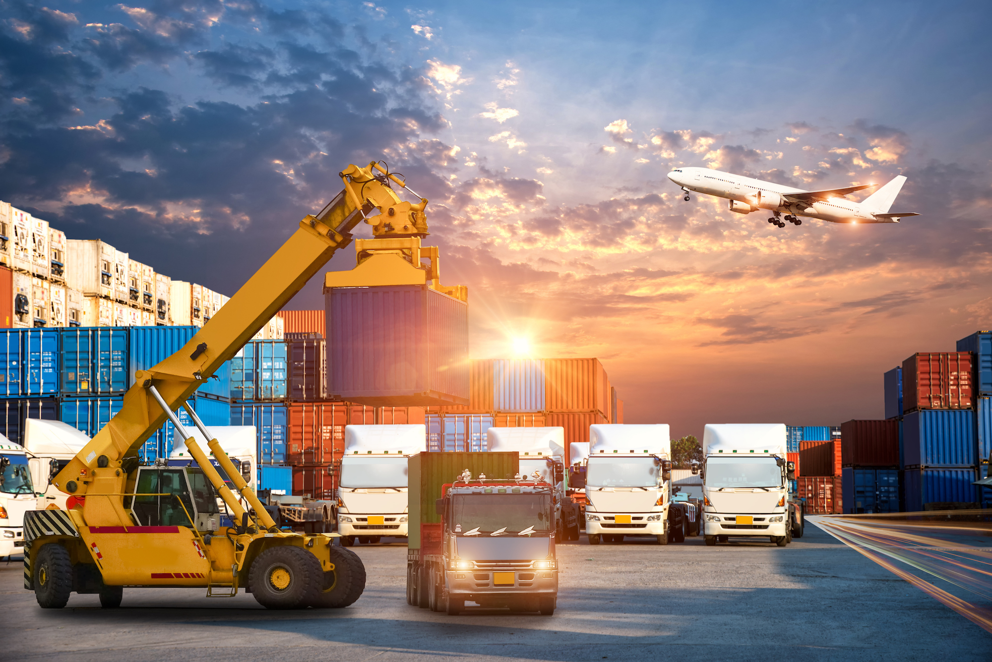 Business Logistics and transportation concept of Container Cargo ship and Cargo plane with working crane bridge in shipyard at sunrise, logistic import export and transport industry background (Business Logistics and transportation concept of Containe