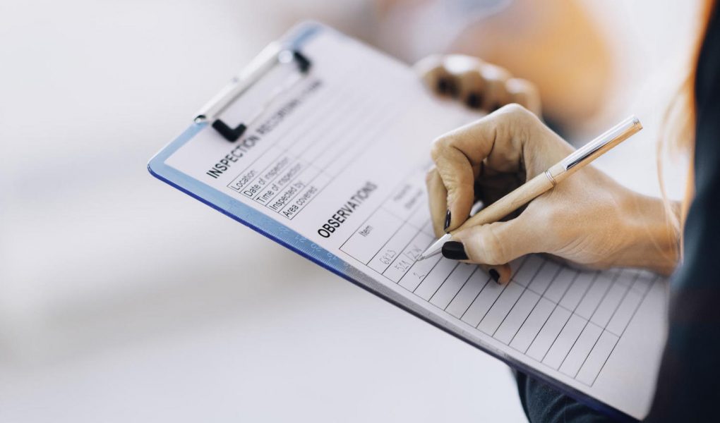 Facility management technician filling inspection form Facility management technician filling inspection form